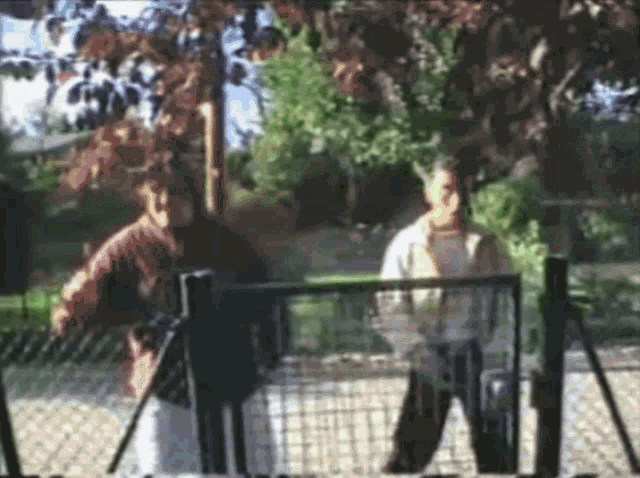 a blurry photo of two people playing tennis
