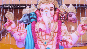 a statue of a deity with many faces and the words kulfyapp.com in the bottom right corner