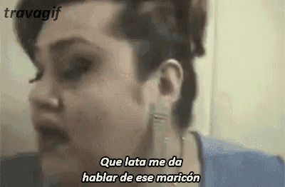 a close up of a woman 's face with the words `` que lata me da hablar de ese maricon '' written on it .