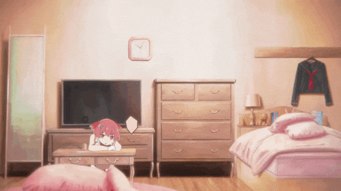 a room with a clock on the wall and a girl sitting on a desk