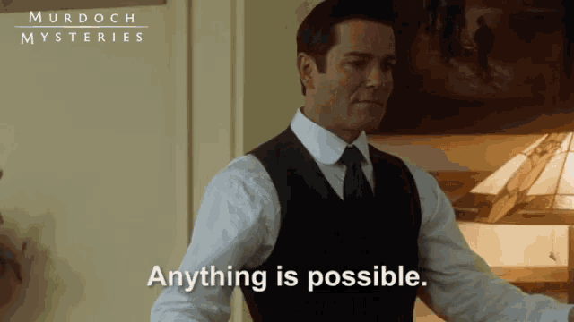 a man in a white shirt and black vest says murdoch mysteries