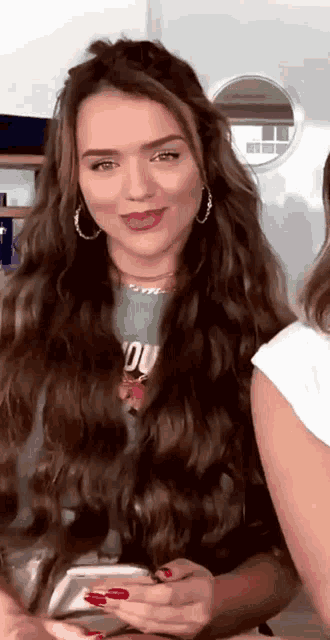 a woman with long hair is wearing a green shirt that says " you "