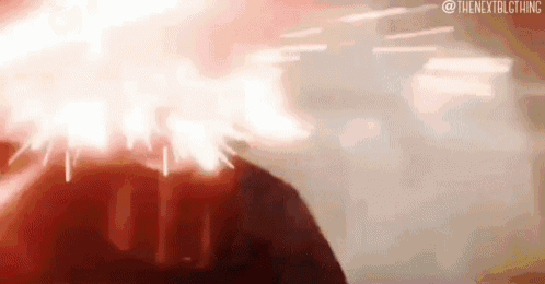 a close up of a person 's head with a red light coming from it .