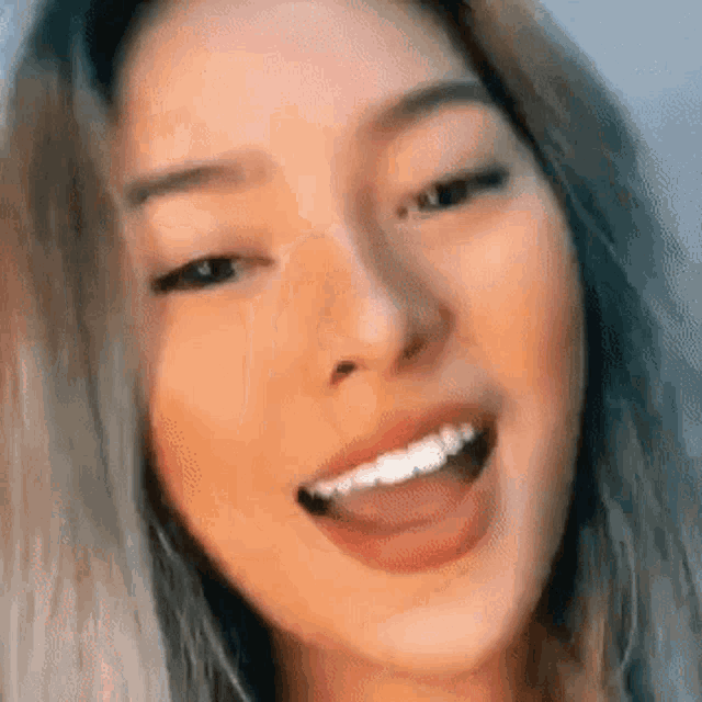 a close up of a woman 's face with her tongue sticking out .