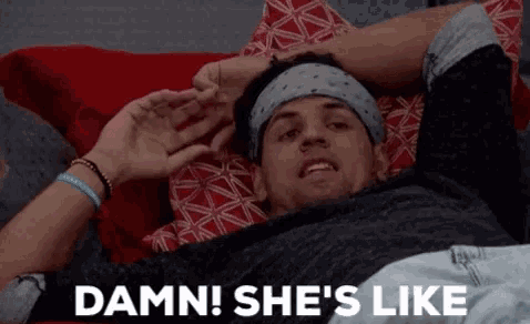 a man laying on a bed with the words damn she 's like