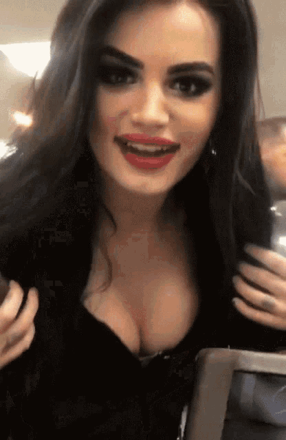 a woman with red lips and a plunging neckline is smiling