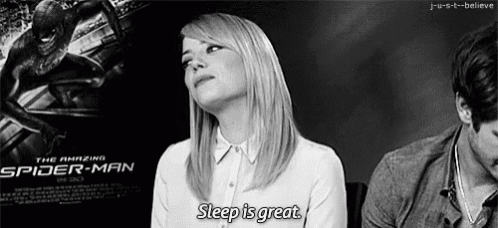 a woman is sitting in front of a poster for the amazing spider-man and says sleep is great .