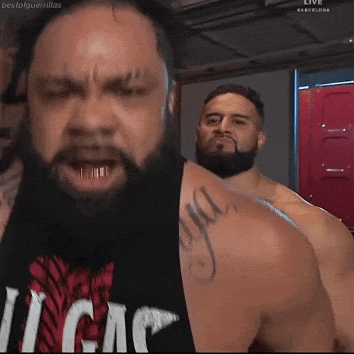 a man with a beard is wearing a black tank top that says vegas on it