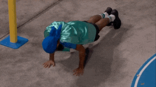 a man in a superhero costume is doing push ups while wearing a cape