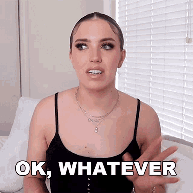 a woman wearing a black tank top says " ok whatever "
