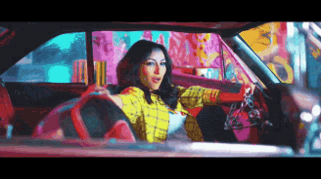 a woman in a plaid shirt is driving a car