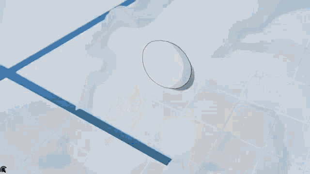 a white egg is sitting on top of a snowy surface .