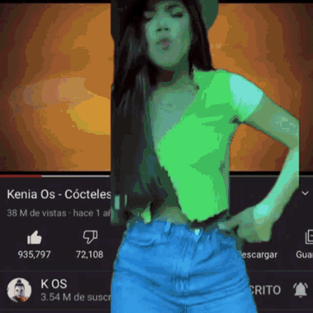 a woman in a green shirt and blue jeans is dancing