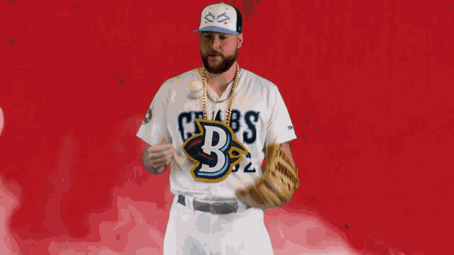 a baseball player wearing a crabs jersey throws a baseball