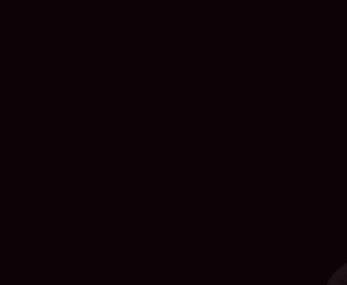 a man in a black shirt is making a funny face with his mouth open