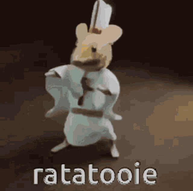 a cartoon mouse wearing a chef 's hat and a tie is dancing .