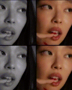 a close up of a woman 's face with a toothpick in her mouth .