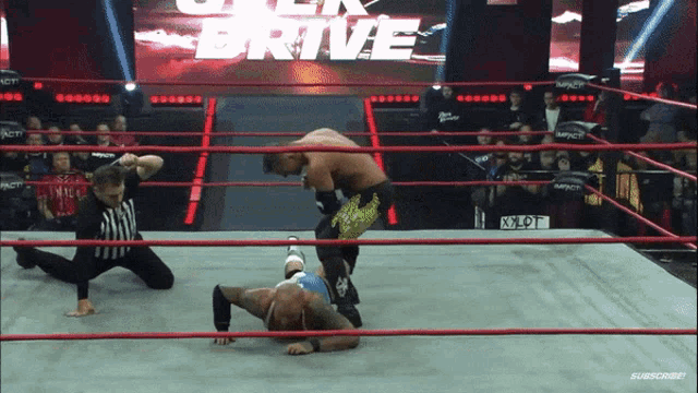 a wrestling ring with a sign that says drive on it