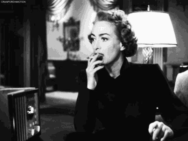 a black and white photo of a woman smoking a cigarette with the caption " cramford motion " at the bottom