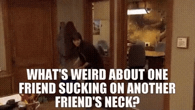what 's weird about one friend sucking on another friend 's neck ? a man is standing in a room .