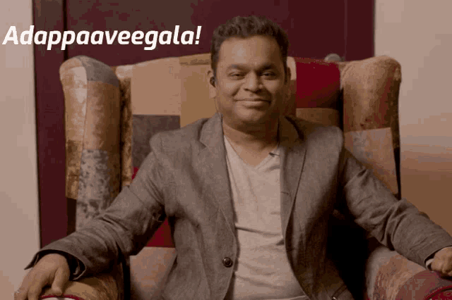 a man in a suit is sitting in a chair with the words adappaaveegala behind him