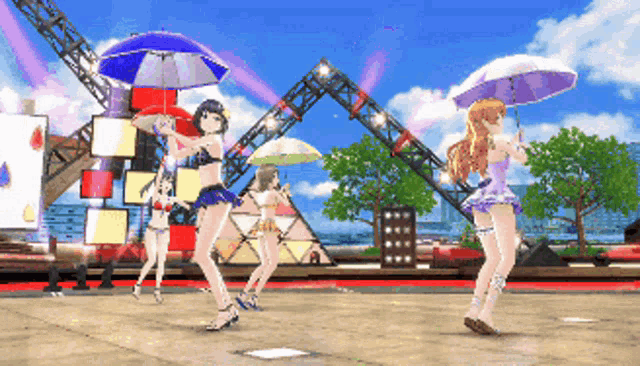 a group of girls dancing with umbrellas in front of a stage