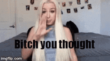 a woman with long blonde hair is sitting on a bed with her hand on her face and the words `` bitch you thought '' .