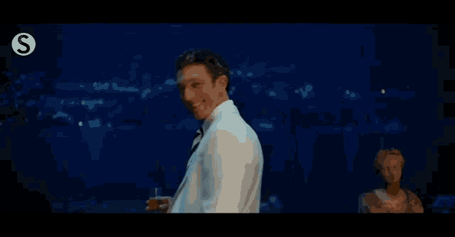 a man in a suit and tie is holding a lighter in his hand