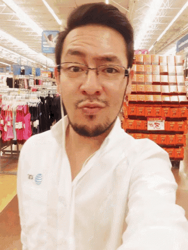 a man wearing glasses and a shirt that says at & t on it