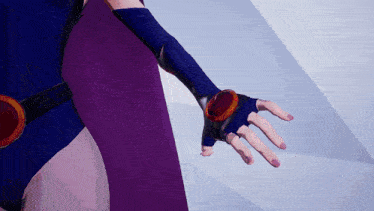 a close up of a person 's hand wearing a purple glove