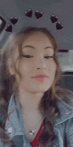 a girl in a car with hearts on the roof