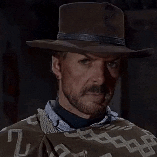 a man wearing a cowboy hat is holding a chain