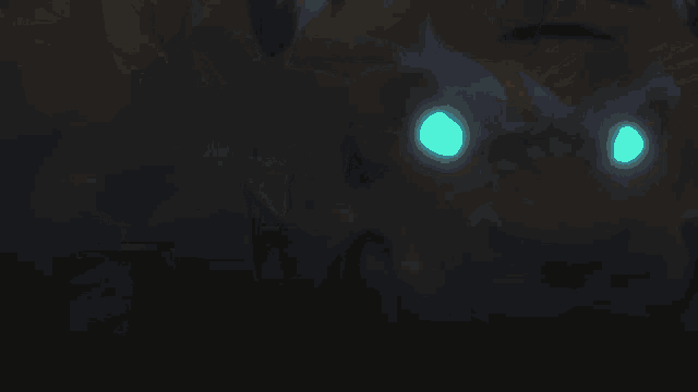 a close up of a monster 's eyes that are glowing blue