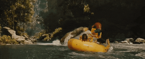 a person is riding a yellow raft in a waterfall