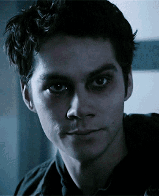 a close up of a man with black eyes