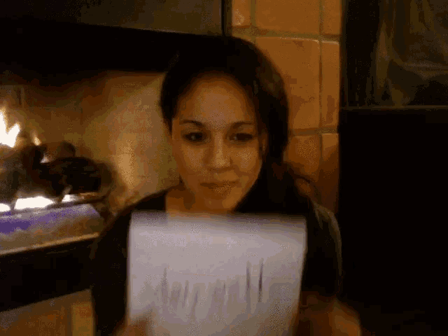 a woman is holding a piece of paper that says ' amanda ' on it