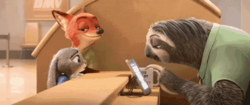 a sloth is looking at a cell phone while a fox and a rabbit look on .