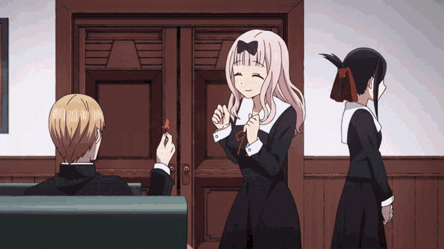 a girl with a bow on her head is smiling while a boy sits in a chair
