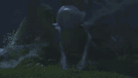 a toothless from how to train your dragon is sitting in the grass at night .