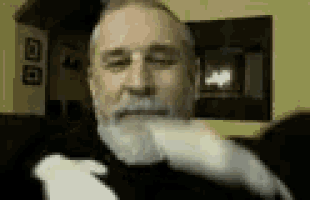 a man with a beard is sitting on a couch with his eyes closed