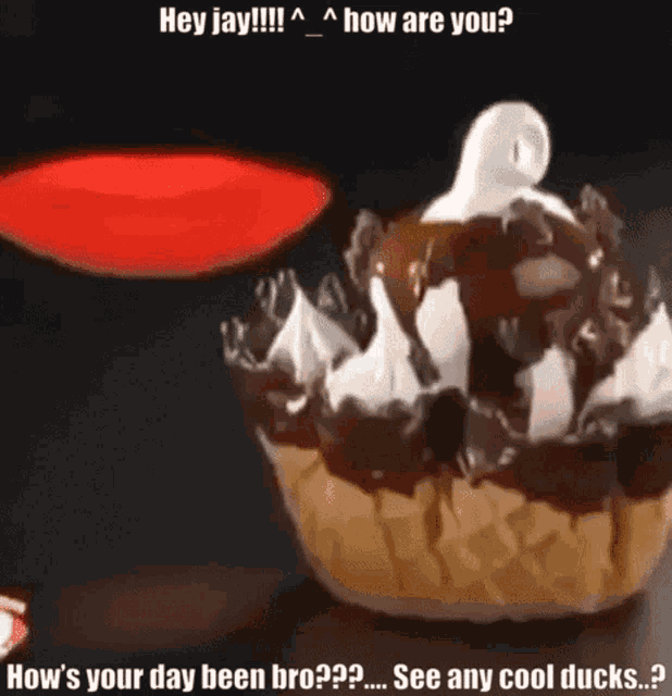 a cupcake with chocolate sauce and whipped cream has a ghost on top of it
