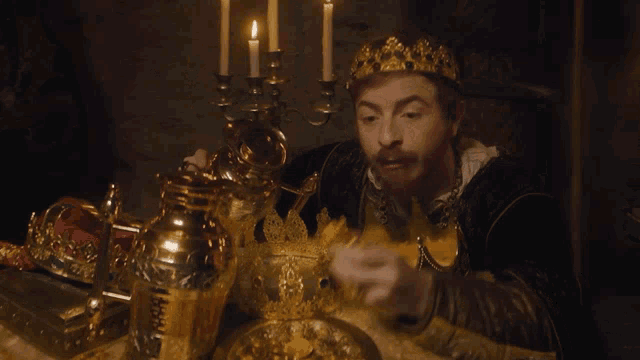 a man with a crown on his head holds a gold coin in his hand
