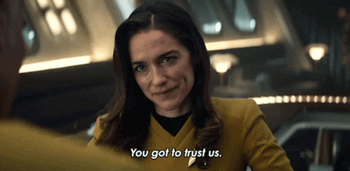 a woman in a yellow uniform says you got to trust us
