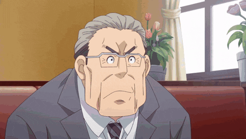 a man wearing glasses and a suit looks angry