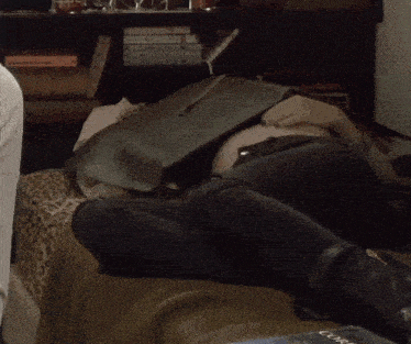 a person laying on a bed with a book on their lap that says ' courage ' on it