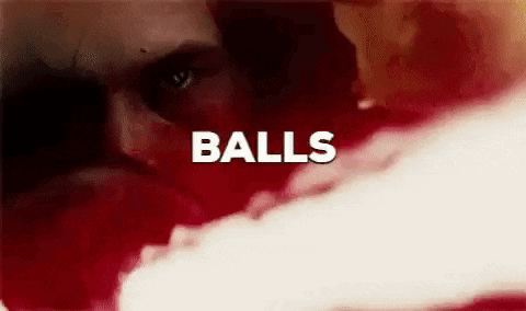 a close up of a person 's face with the words `` balls '' written on it .