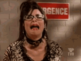a woman is crying in front of a sign that says " urgence "