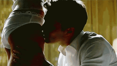 a man is kissing a woman 's butt while she is wearing white underwear