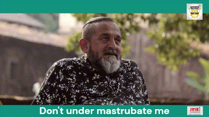 a man with a beard is sitting in front of a sign that says don 't under mastrubate me