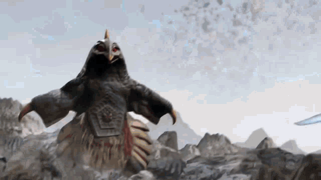 a monster is standing on top of a pile of rocks in the mountains .